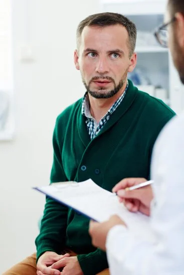 Young man listening to doctor consultation in medical office